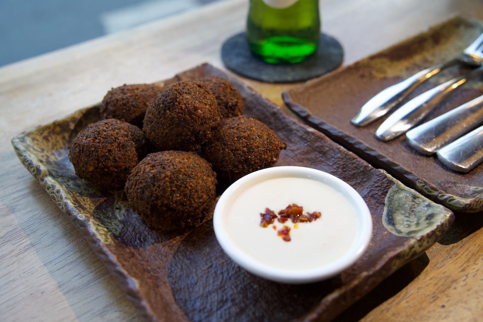 Crispy golden falafel balls served with tahini sauce and fermented chilli