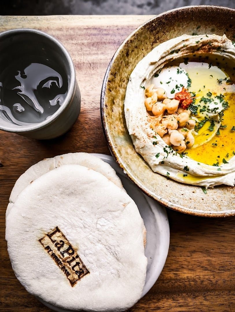 LaPita branded pita bread with creamy hummus topped with chickpeas and olive oil